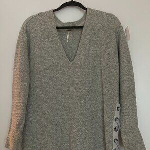 Free People gray 32" long sweater with ribbon detail.